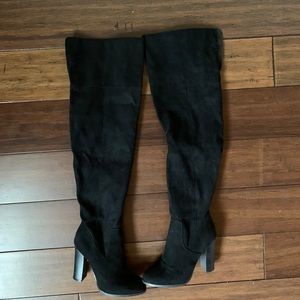 Black thigh high boots.